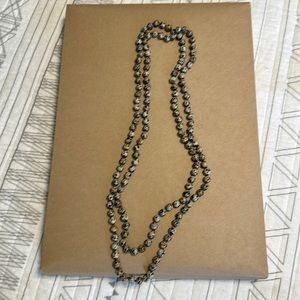 Long beaded necklace. Black speckled.